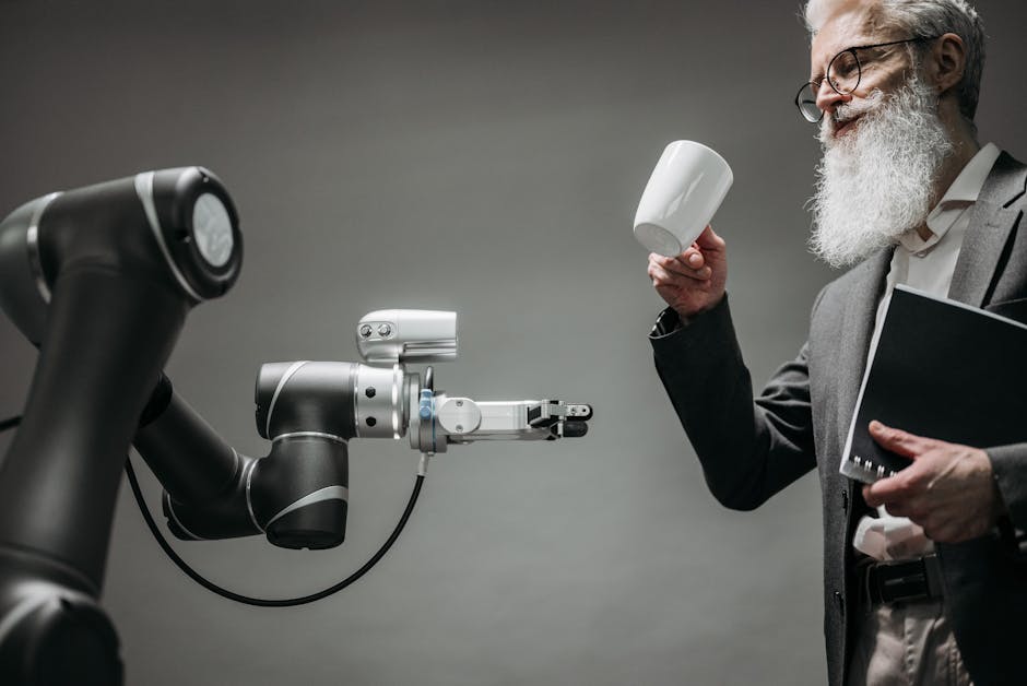 A bearded engineer holds a ceramic cup while a robotic arm assists, showcasing modern technology.